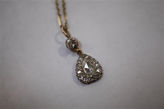 A Victorian style gold and diamond inverted heart shape pendant necklace, 0.75in inc. bale.